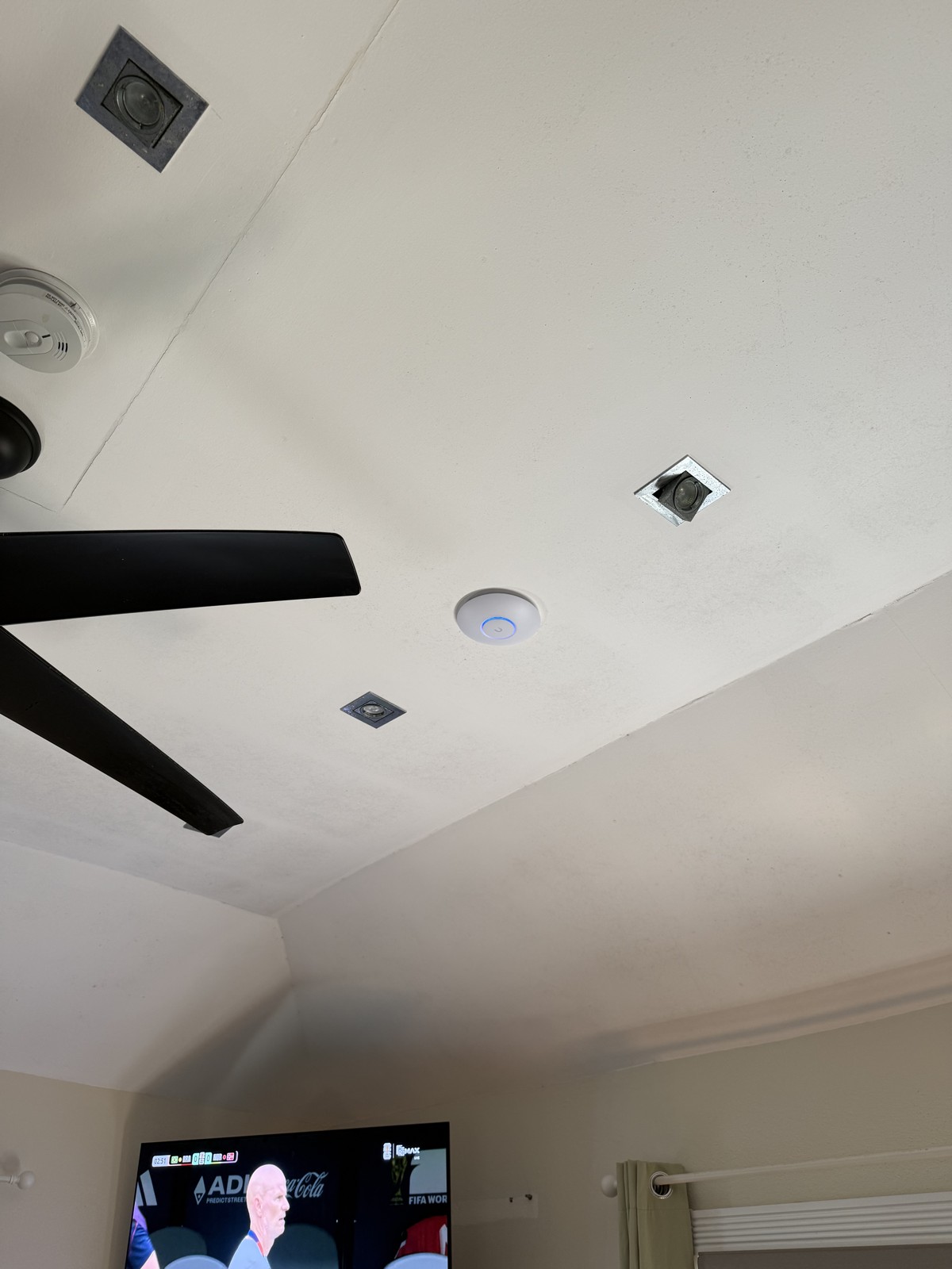 Ceiling access point on a vaulted ceiling with in-ceiling speakers