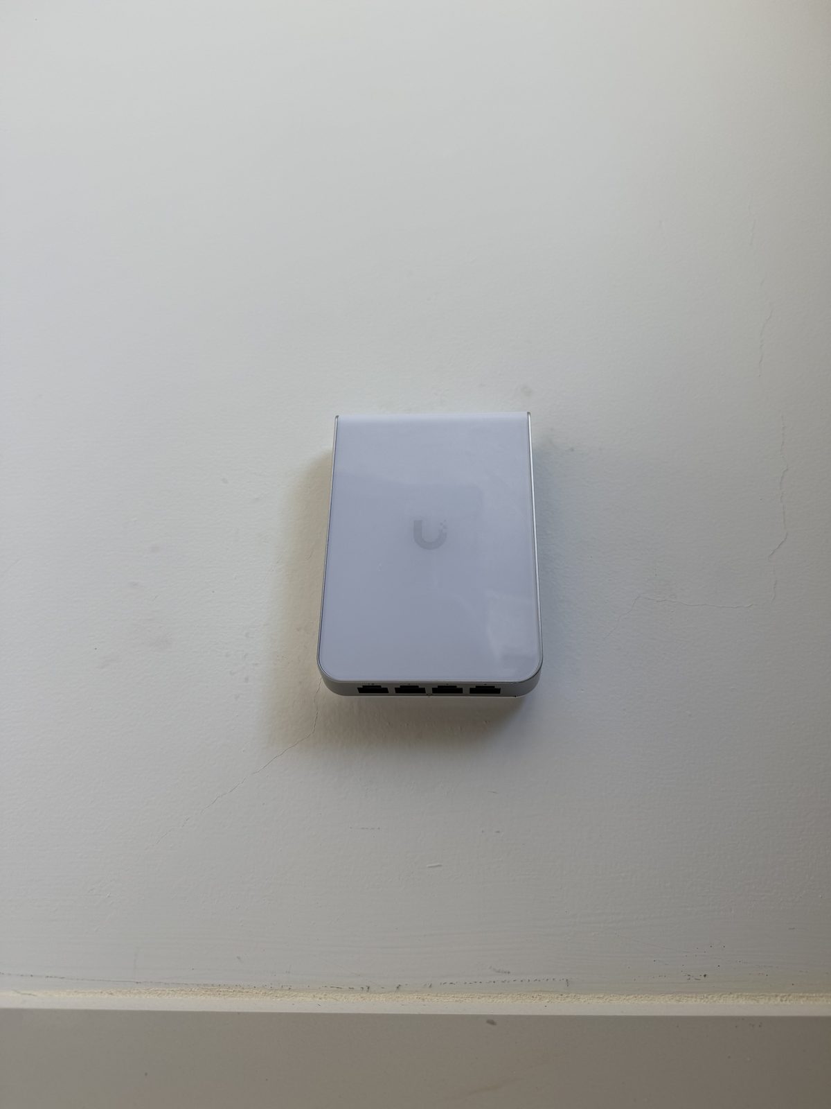 UniFi U7 In-Wall access point - flush to the wall with four wired ports underneath