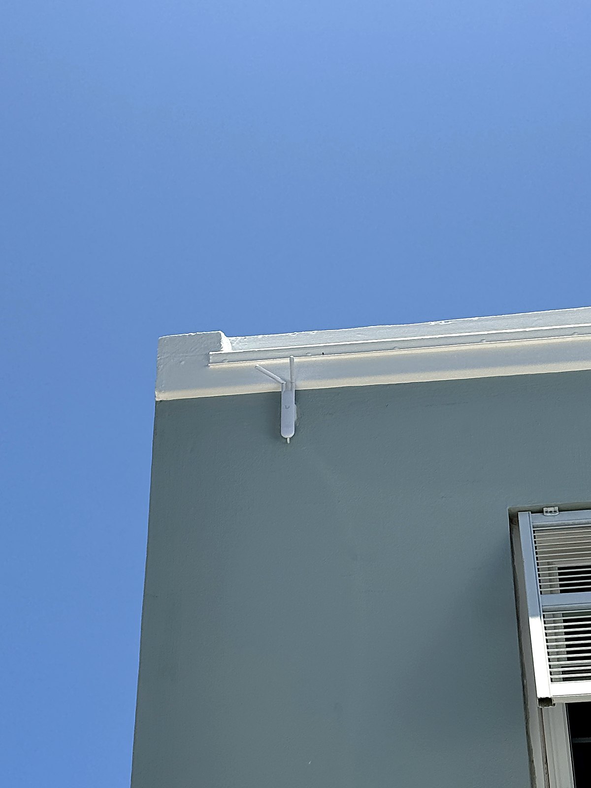 Outdoor UniFi access point on the roofline for exterior coverage