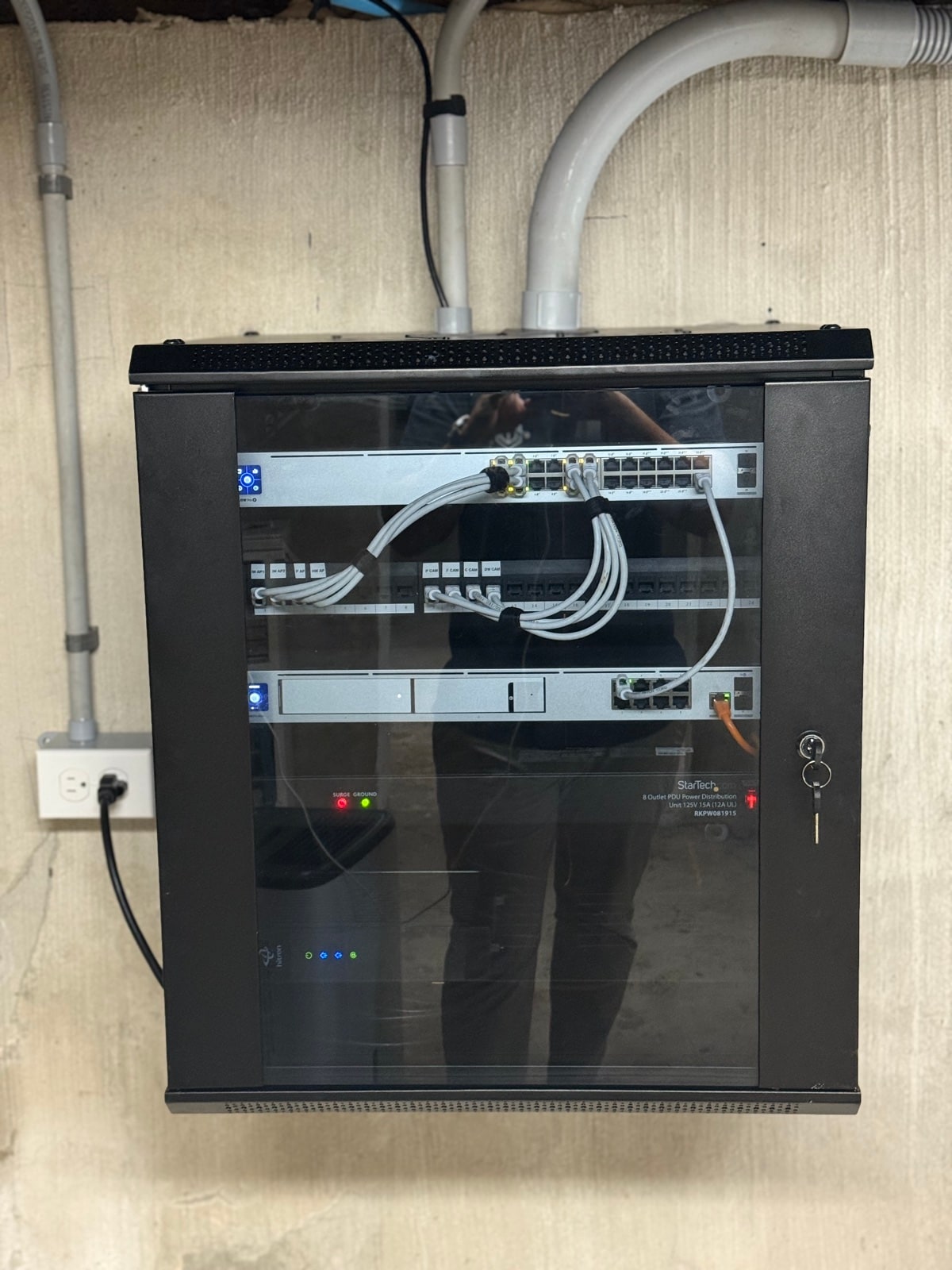 Wall-mounted network rack with glass front door