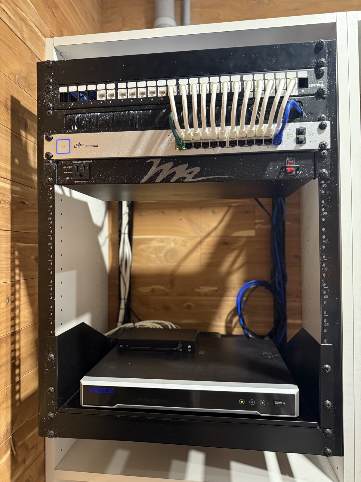 Open-frame rack with patch panel, switch and recorder