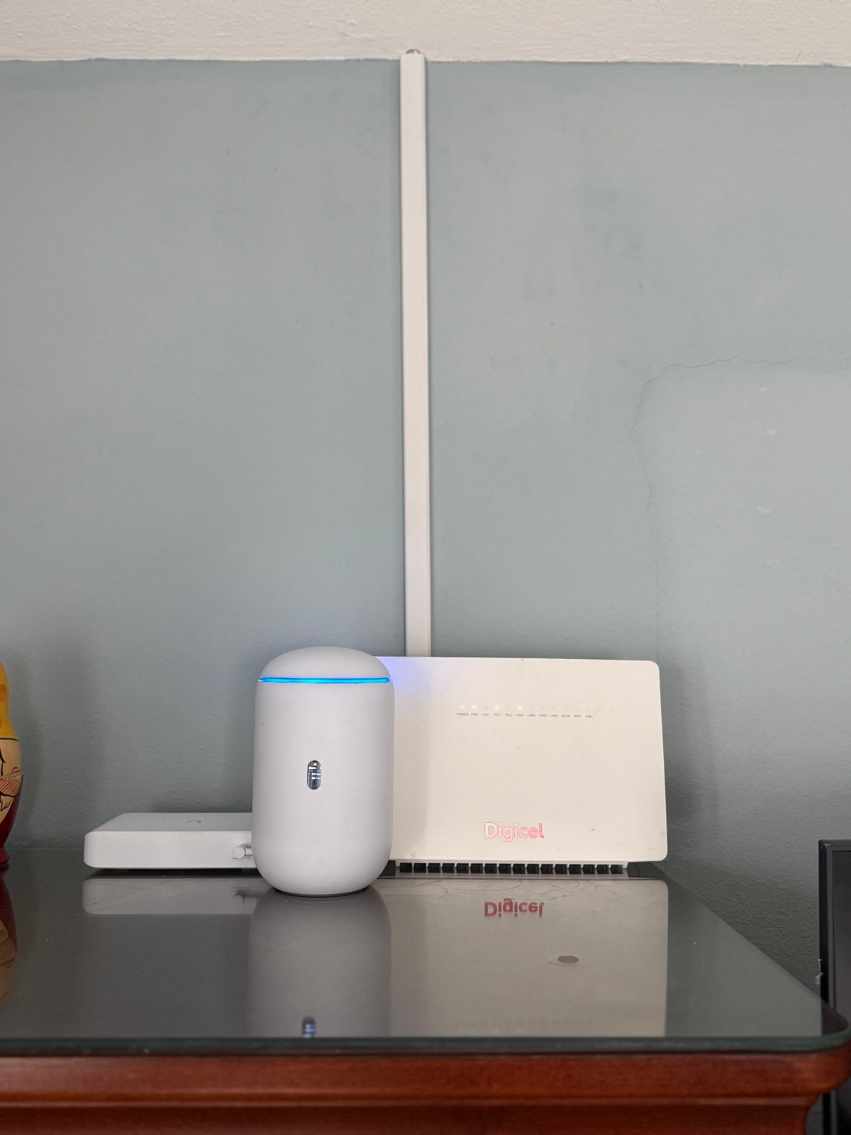 UniFi gateway alongside ISP modem - clean shelf install