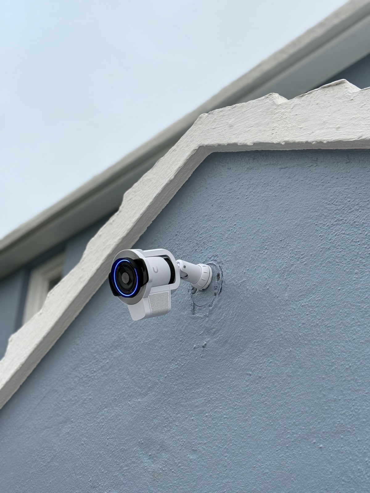 Bullet camera tucked under a blue gable - active recording