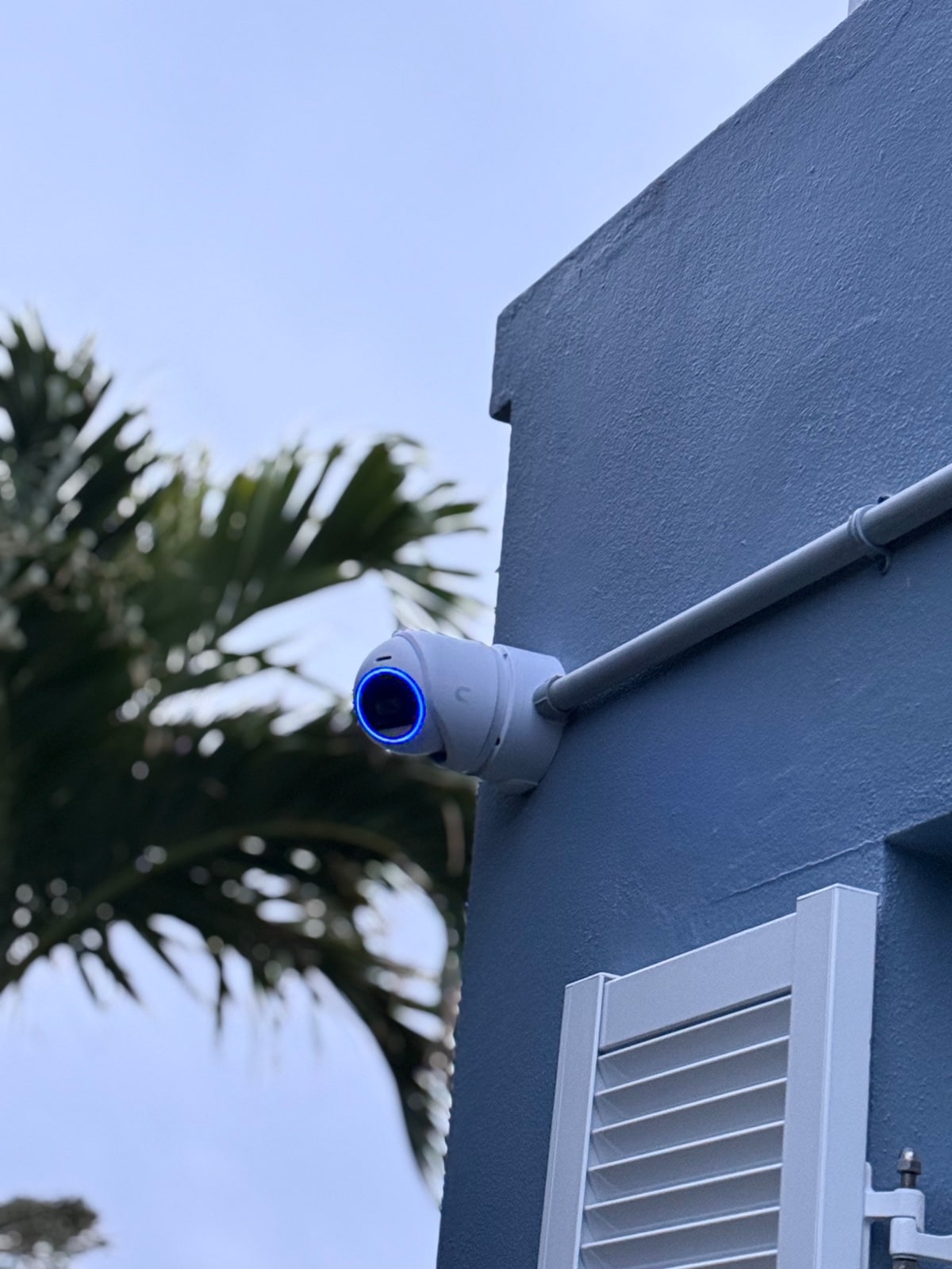 Outdoor bullet camera on a blue Bermuda home