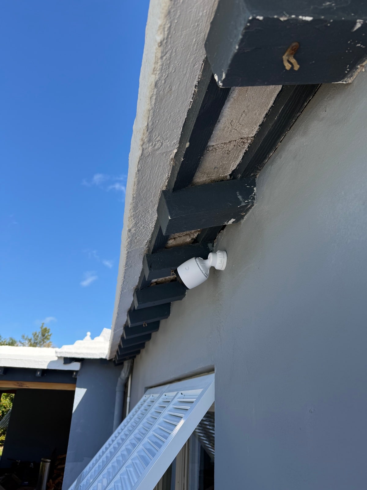 Bullet camera mounted under wood eaves