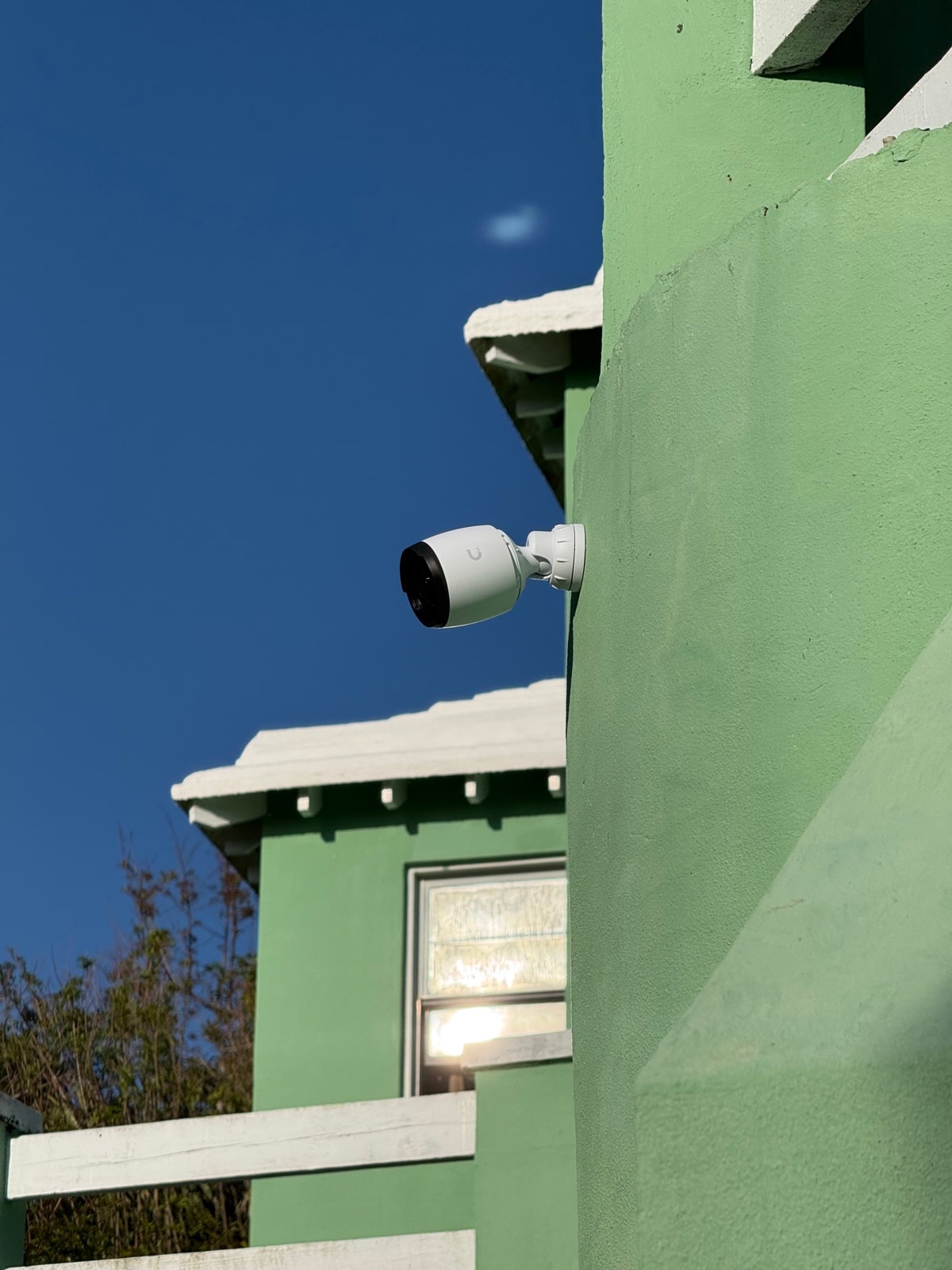 Bullet camera on the corner of a green Bermuda cottage