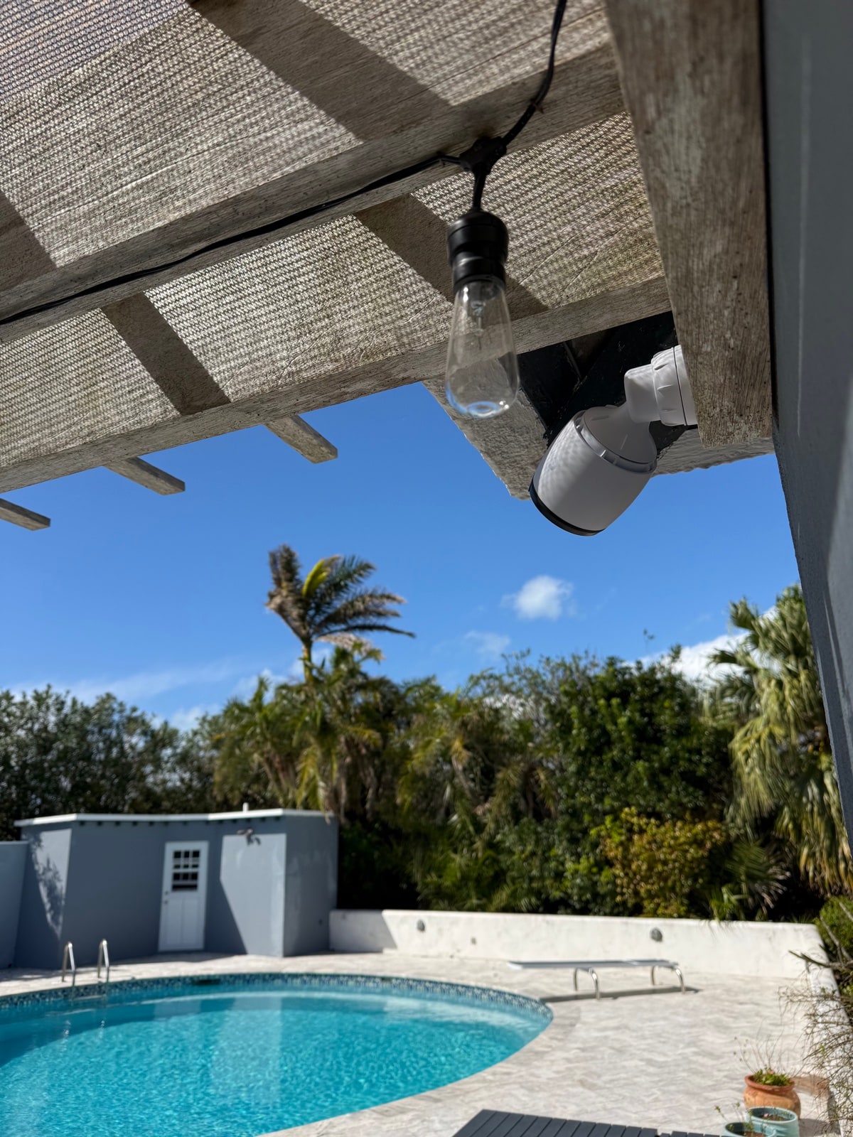 Camera tucked under the patio awning by the pool deck